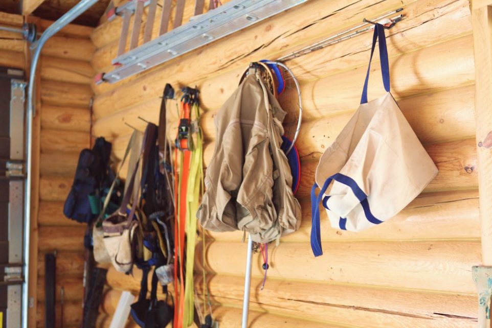 Cabin supplies and equipment hanging up in a garage, ready to be used for fishing, working and other activities.